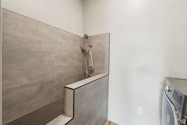 Interior space with tiled shower and washer / clothes dryer | Image 43