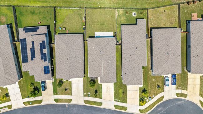 An aerial view clearly showing the new roof installed in July 2025, while also highlighting the home's position relative to neighboring properties. | Image 30
