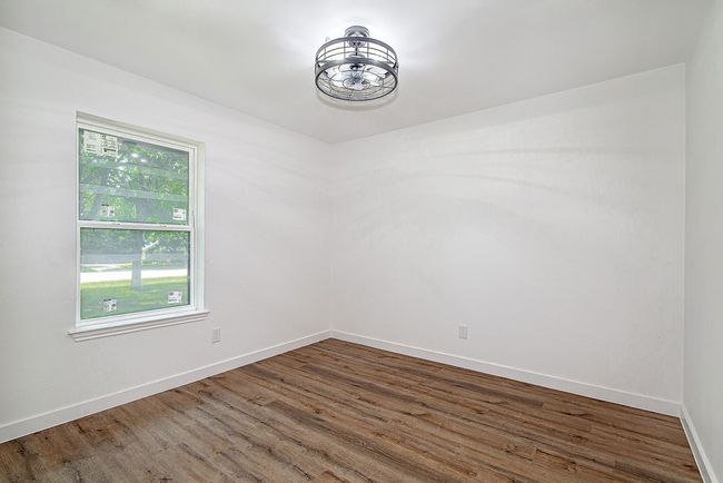 Spare room featuring wood finished floors and baseboards | Image 26