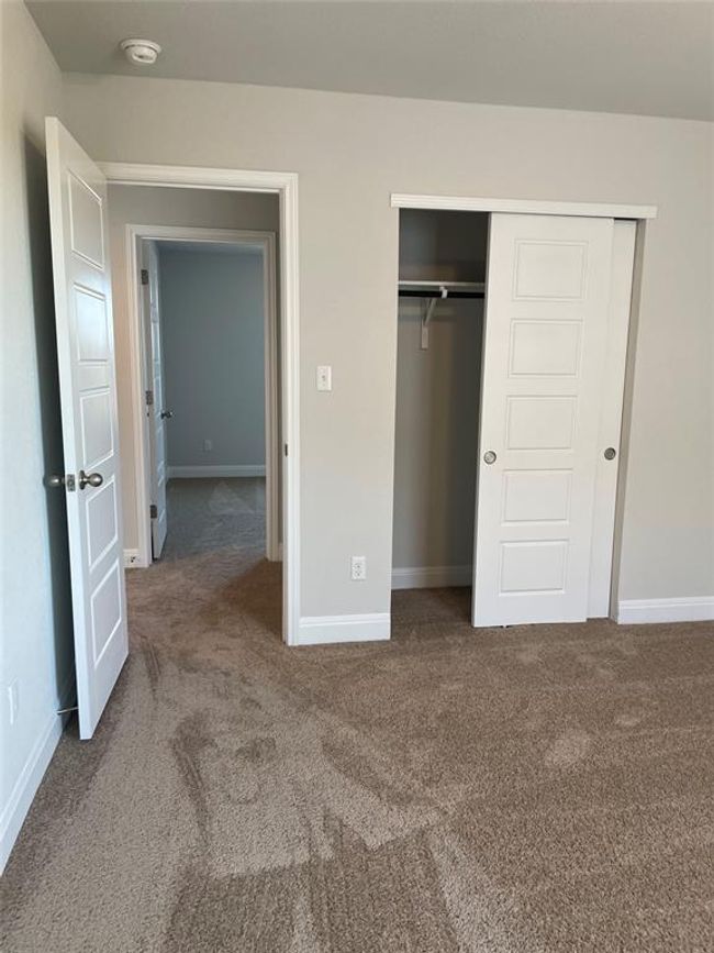 Unfurnished bedroom with carpet floors and a closet | Image 21