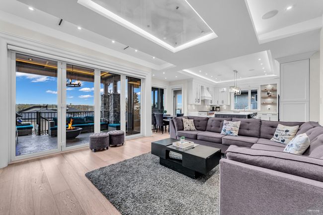 Living room with recessed lighting, light wood finished floors, and a raised ceiling | Image 27