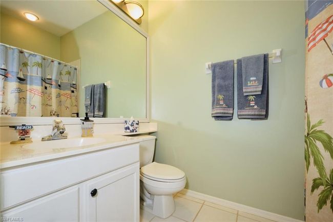 Bathroom with toilet, vanity, and tile patterned flooring | Image 45