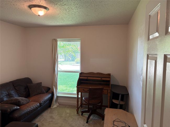 Carpeted office featuring healthy amount of natural light and a textured ceiling | Image 11