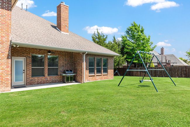 View of yard featuring fence private yard, a patio area, and a playground | Image 39