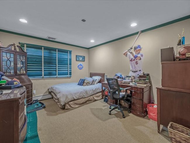 Bedroom with carpet floors, crown molding, an office area, recessed lighting, and baseboard heating | Image 23