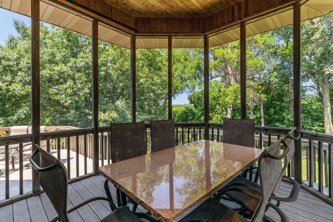 What an awesome, 3-season porch located off kitchen! This is the 2nd of two screen porches on the back of this home. | Image 52