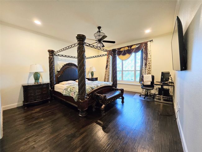Bedroom featuring baseboards, crown molding, wood finished floors, and recessed lighting | Image 23
