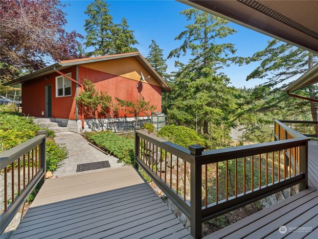There is a bridge that crosses over the rocks from the first floor to the garage and parking. | Image 5