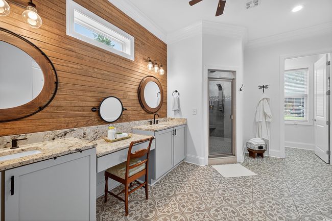 Full bathroom with wooden walls, vanity, ornamental molding, ceiling fan, and a stall shower | Image 22