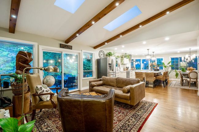 Living room with a chandelier, recessed lighting, light wood-type flooring, and a skylight | Image 5