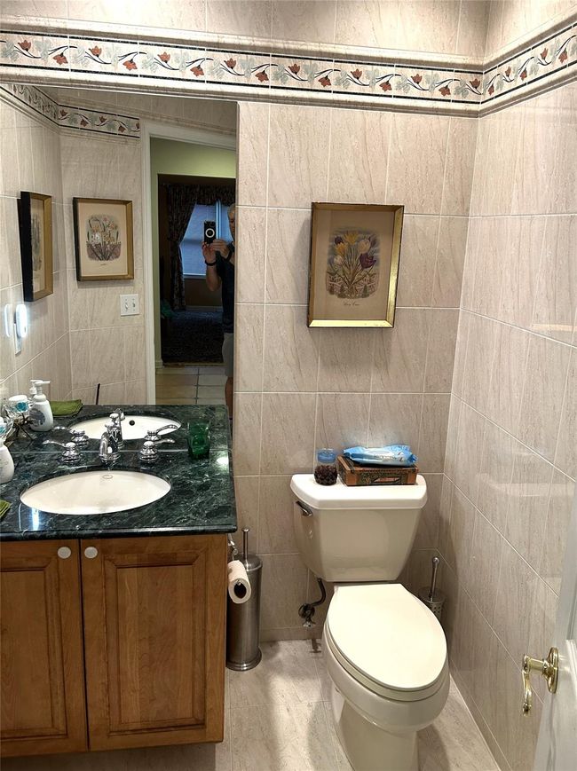 Half bathroom featuring tile walls and vanity | Image 23