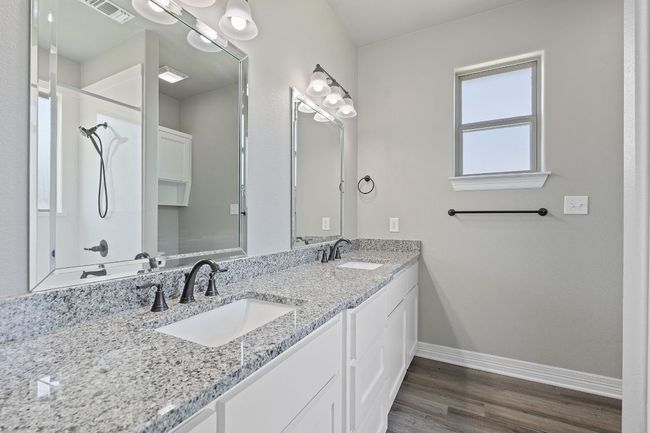 Bathroom with double vanity, wood finished floors, and a shower | Image 20
