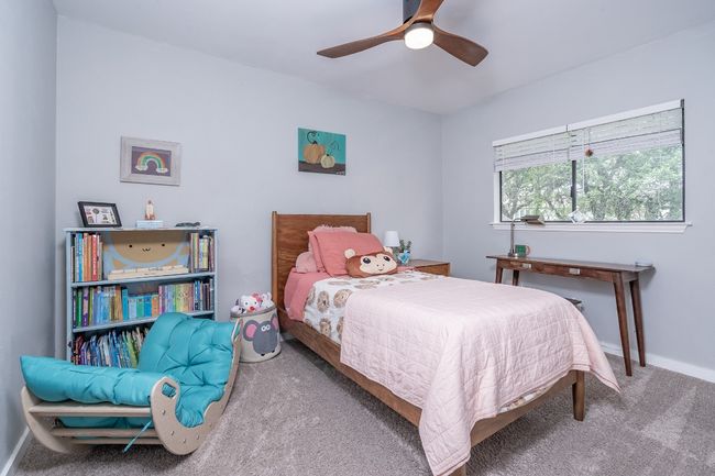 Bedroom with baseboards, carpet flooring, and ceiling fan. Walk in closet. | Image 24