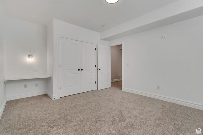 Unfurnished bedroom with carpet flooring and a closet | Image 33