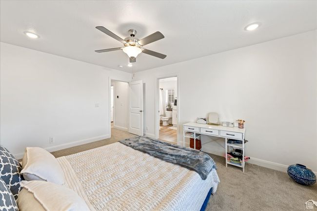 Bedroom featuring light carpet, recessed lighting, a ceiling fan, and ensuite bathroom | Image 20