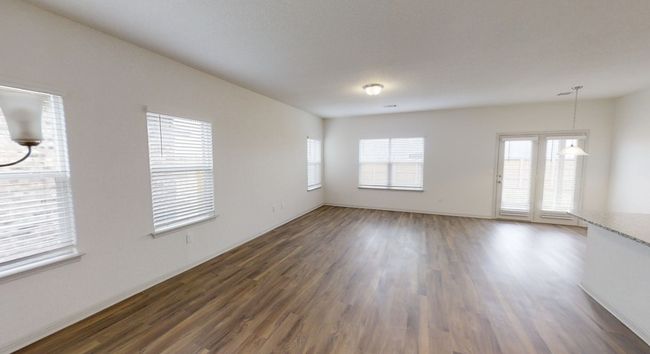 Empty room with dark wood-type flooring and plenty of natural light | Image 6