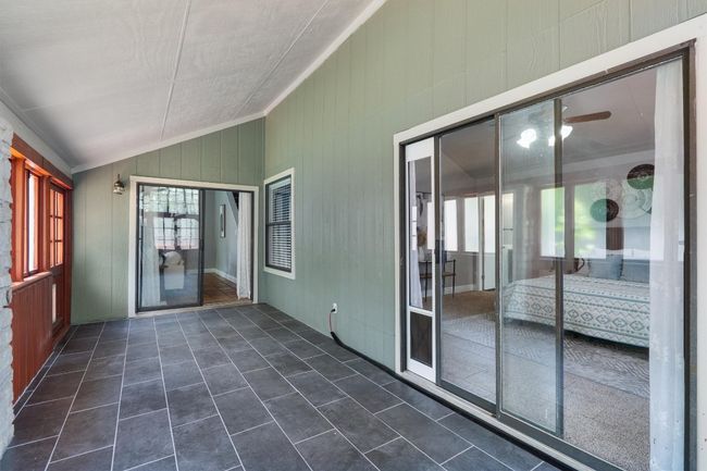 Unfurnished sunroom featuring vaulted ceiling | Image 19