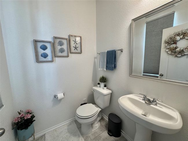 Bathroom with a sink and tile patterned flooring | Image 7