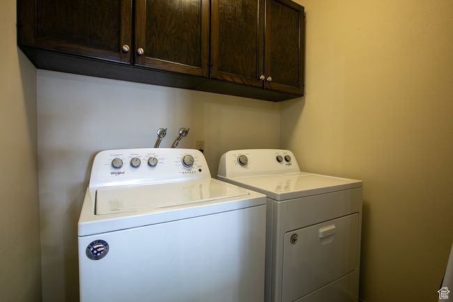 Laundry room featuring cabinet space and washer and clothes dryer | Image 20