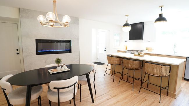 The dining room area is beautifully elevated by this newly added electric fireplace, which has multiple heat settings and offers several different color options. It can also be set to not emanate heat, which allows for added ambiance year round. | Image 9