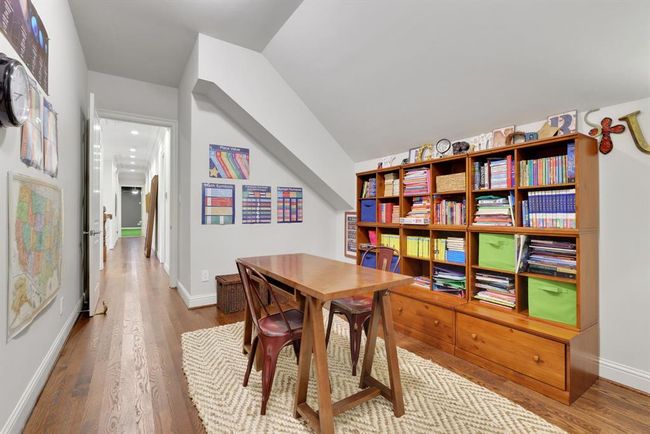 Beyond the hobby room, a flexible-use space awaits—perfect as a study nook, home gym, or creative studio. This room features an angled ceiling, rich hardwood flooring, and the versatility to adapt to your lifestyle needs. | Image 29