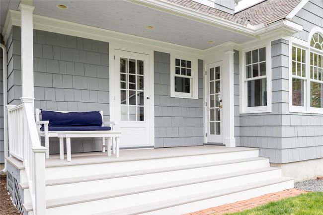 Covered back porch overlooking gardens with doors leading to kitchen and back hallway | Image 5