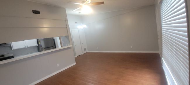 Unfurnished living room with wood finished floors and a ceiling fan | Image 22