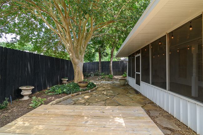 Deck/flagstone patio with a fenced backyard with sprinkler system-there is an area for a pet or grass can be added | Image 20