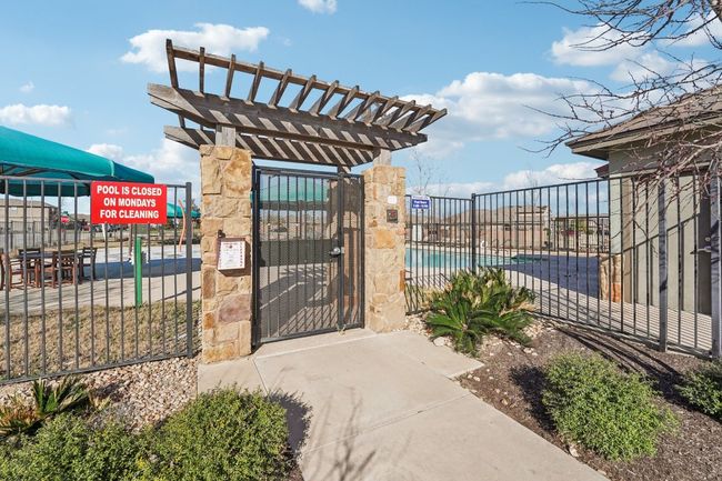 View of gate featuring a pergola and fence | Image 26