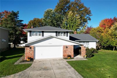 View of front of home featuring a front yard and a garage | Image 1