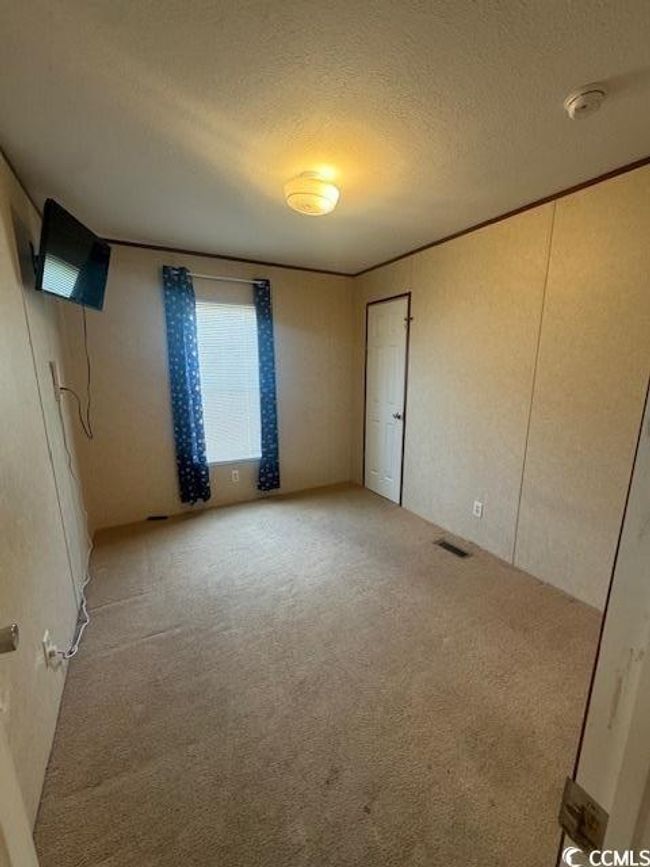 Spare room featuring a textured wall | Image 13