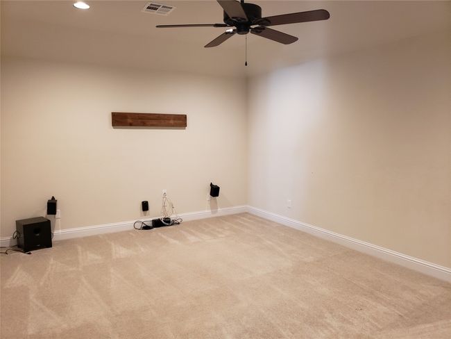 Laundry area with carpet floors, a ceiling fan, and recessed lighting | Image 13