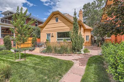 Welcoming front yard with an inviting front porch to relax and watch the Beautiful Colorado Sunsets! | Image 1