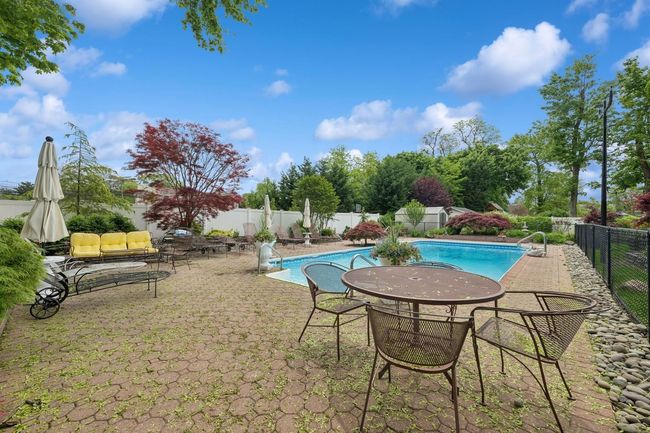 View of pool with a fenced backyard and a patio area | Image 30
