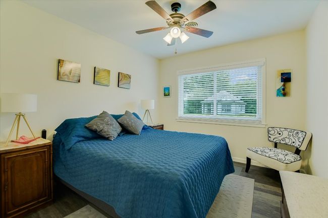 Bedroom featuring dark wood-style flooring, baseboards, and ceiling fan | Image 14