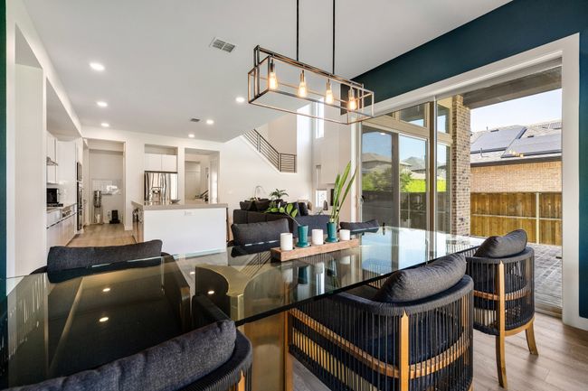 Dining area featuring a chandelier, light wood-style floors, and recessed lighting | Image 19