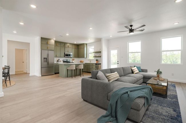 Living area featuring light wood-type flooring, recessed lighting, baseboards, and ceiling fan | Image 5