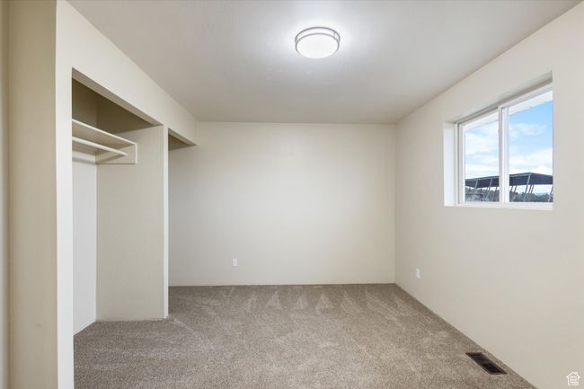 Interior space featuring visible vents and carpet flooring | Image 17