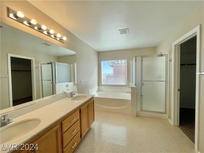 Full bath with double vanity, a garden tub, a shower stall, and a sink | Image 8