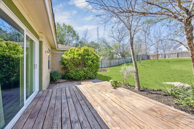 Wooden terrace featuring a yard and a fenced backyard | Image 24