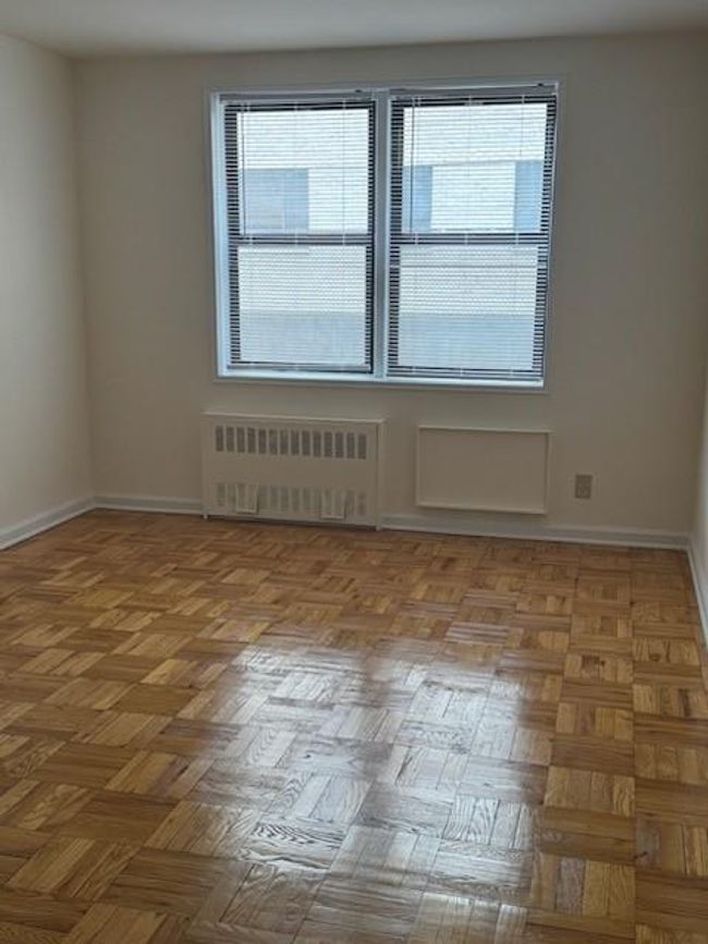 Spare room featuring radiator heating unit and baseboards | Image 11