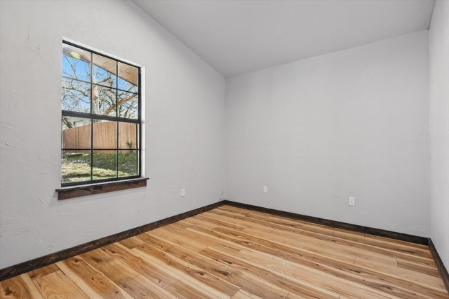 Spare room with wood finished floors and baseboards | Image 26