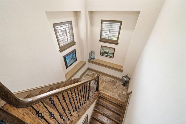 Elegant wood & travertine stairway with windows & shelving | Image 26