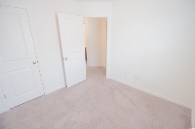 Unfurnished bedroom featuring light colored carpet and baseboards | Image 19
