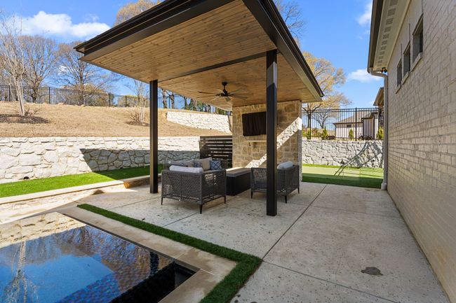 View of patio featuring a fenced backyard, an outdoor hangout area, and ceiling fan | Image 35