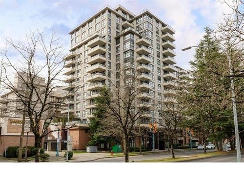 Multi-story building featuring numerous balconies, extensive glazing, and a street-facing entrance | Card Image
