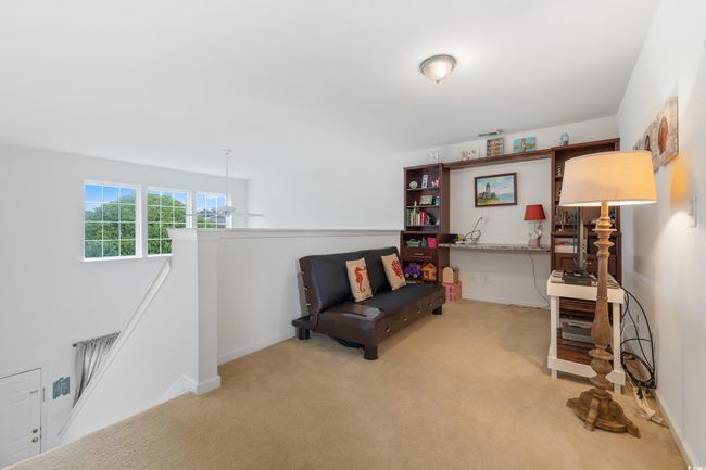 Living area featuring an upstairs landing, carpet floors, and baseboards | Image 25