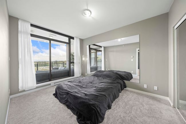 Bedroom featuring carpet floors, baseboards, and access to outside | Image 15