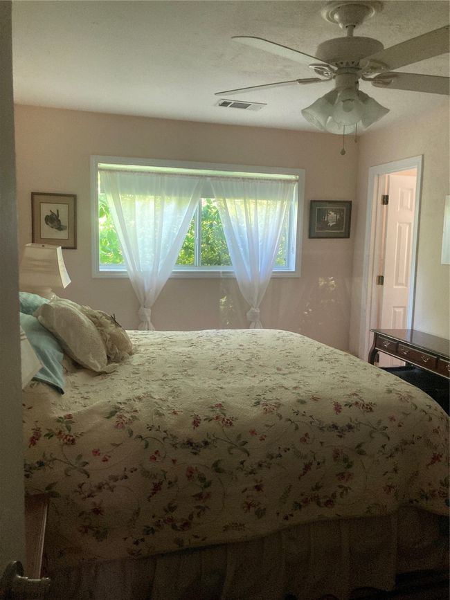 Bedroom featuring multiple windows and a ceiling fan | Image 28