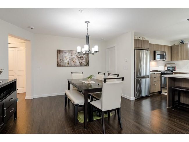 Dining room featuring a chandelier, dark wood finished floors, and baseboards | Image 5